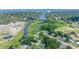Expansive aerial view of a lush neighborhood featuring a winding river and a water treatment facility nearby at 1611 Stevenson Dr, Clearwater, FL 33755