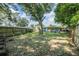 A spacious backyard featuring a large tree and wooden fence that provides privacy at 1611 Stevenson Dr, Clearwater, FL 33755