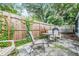 Charming backyard area with fence, lush greenery, and outdoor seating at 1611 Stevenson Dr, Clearwater, FL 33755