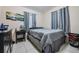 Cozy bedroom with a queen-sized bed, dresser, and ample natural light from two windows at 1611 Stevenson Dr, Clearwater, FL 33755