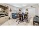 Cozy dining room with a blue couch, tile floors, and a four-chair dining table at 1611 Stevenson Dr, Clearwater, FL 33755