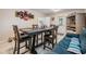Dining room with a blue couch, tile floors, and a four-chair dining table at 1611 Stevenson Dr, Clearwater, FL 33755