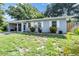 Charming single-story home featuring a well-manicured lawn and covered parking at 1611 Stevenson Dr, Clearwater, FL 33755