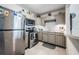 Charming kitchen featuring stainless steel appliances, gray cabinets, and a tile backsplash at 1611 Stevenson Dr, Clearwater, FL 33755