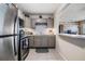 Charming kitchen featuring stainless steel appliances, gray cabinets, and a tile backsplash at 1611 Stevenson Dr, Clearwater, FL 33755