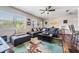 Bright and airy living room features plush seating, large windows, wood floors and a modern rug at 1611 Stevenson Dr, Clearwater, FL 33755