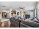 Open-concept living room featuring wood floors, modern decor, ceiling fan, and access to kitchen at 1611 Stevenson Dr, Clearwater, FL 33755
