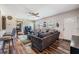 Relaxing living room with a leather sofa, ceiling fan, hard wood floors and large windows at 1611 Stevenson Dr, Clearwater, FL 33755