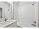 Simple bathroom with white subway tiles, a bathtub, and a vanity with a quartz countertop at 6605 N Nebraska Ave # 27, Tampa, FL 33604