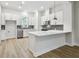 Modern kitchen featuring white cabinets, quartz countertops, and stainless steel appliances at 6605 N Nebraska Ave # 27, Tampa, FL 33604