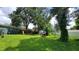 Spacious backyard with green grass and a play area, ideal for Gathering fun and outdoor entertainment at 8013 N Ola Ave, Tampa, FL 33604