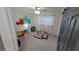 Bright bedroom with a large window, cheerful decor and carpet flooring creating a playful and inviting atmosphere at 8013 N Ola Ave, Tampa, FL 33604
