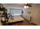 Bright bedroom with hardwood floors, a ceiling fan, and a large window at 8013 N Ola Ave, Tampa, FL 33604