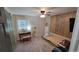 A simple bedroom with natural light, wood accent wall, and carpet floors makes the room feel more inviting at 8013 N Ola Ave, Tampa, FL 33604