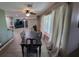 Open-concept dining area with modern lighting and a dark wood table, seamlessly flowing into the living space at 8013 N Ola Ave, Tampa, FL 33604