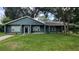 Charming single-story home with a well-maintained lawn and freshly painted exterior with neutral trim at 8013 N Ola Ave, Tampa, FL 33604