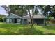 Attractive single-Gathering home with mature trees, freshly painted exterior, and a welcoming covered porch at 8013 N Ola Ave, Tampa, FL 33604