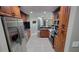 Well-appointed kitchen with stainless steel appliances, granite countertops, and wood cabinetry at 8013 N Ola Ave, Tampa, FL 33604