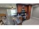 Spacious kitchen area featuring a breakfast bar, stainless steel appliances, and wood cabinetry at 8013 N Ola Ave, Tampa, FL 33604