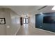 Open-concept living area with neutral paint, tiled floor, ceiling fan and views of backyard at 8013 N Ola Ave, Tampa, FL 33604
