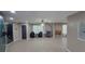 Living room with an accent wall, tile flooring, ceiling fan, modern lighting fixtures, and furnishings at 8013 N Ola Ave, Tampa, FL 33604
