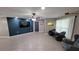 Living room with an accent wall, tile flooring, ceiling fan, and modern lighting fixtures at 8013 N Ola Ave, Tampa, FL 33604