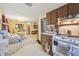 Open kitchen with view into dining area and living room at 1240 Chelsea Ln, Holiday, FL 34691