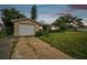 House exterior featuring a single car garage and a spacious front yard at 1240 Chelsea Ln, Holiday, FL 34691