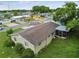 Aerial view of a single Gathering home and surrounding neighborhood at 1240 Chelsea Ln, Holiday, FL 34691