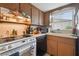 Kitchen features a white stove, dishwasher, and wood cabinets at 1240 Chelsea Ln, Holiday, FL 34691