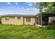 Backyard view showing a home with a screened patio at 1240 Chelsea Ln, Holiday, FL 34691