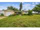 House exterior with a large grassy yard and a single car garage at 1240 Chelsea Ln, Holiday, FL 34691