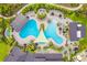 Aerial view of community pool with lounge chairs and shade structures at 33857 Landsman Loop, Wesley Chapel, FL 33543