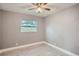 Bedroom with gray walls, ceiling fan, and a window offering natural light at 4420 W Varn Ave, Tampa, FL 33616