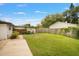 Large backyard with grassy area and wooden deck at 750 Roanoke St, Dunedin, FL 34698