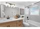 Modern bathroom with updated vanity, bathtub, and marble tile at 750 Roanoke St, Dunedin, FL 34698