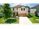 Two-story house with a brown garage door and stone accents at 1181 Montgomery Bell Rd, Wesley Chapel, FL 33543