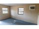 Small room with two windows, painted walls, and a window air conditioner at 2413 Stonehill Ave, Valrico, FL 33594