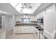 Updated kitchen with white cabinets and a skylight at 2440 Winding Creek Blvd # 201, Clearwater, FL 33761