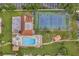 Top-down view of pool, tennis court, and surrounding grounds at 2440 Winding Creek Blvd # 201, Clearwater, FL 33761
