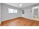 Bright bedroom featuring hardwood floors and access to the bathroom at 2440 Winding Creek Blvd # 201, Clearwater, FL 33761