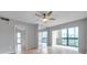Living room with mirrored wall and balcony access at 2440 Winding Creek Blvd # 201, Clearwater, FL 33761