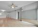 Open living space showcasing mirrored accent wall and wood floors at 2440 Winding Creek Blvd # 201, Clearwater, FL 33761