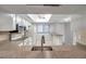 Kitchen boasts granite countertops, white cabinets and a pass-through to the living area at 2440 Winding Creek Blvd # 201, Clearwater, FL 33761