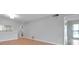 Spacious living area featuring light walls and wood-look flooring at 2440 Winding Creek Blvd # 201, Clearwater, FL 33761