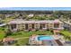 Aerial showing building, pool, tennis courts, and parking at 2440 Winding Creek Blvd # 201, Clearwater, FL 33761