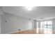 Bright living room with wood floors and sliding glass doors leading to a balcony at 2440 Winding Creek Blvd # 201, Clearwater, FL 33761