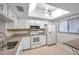 Bright kitchen with white cabinets, stainless steel appliances, and granite countertops at 2440 Winding Creek Blvd # 201, Clearwater, FL 33761