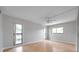 Bedroom with hardwood floors, ceiling fan and two windows at 2440 Winding Creek Blvd # 201, Clearwater, FL 33761