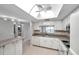 Bright kitchen, white cabinets, granite counters, and skylight at 2440 Winding Creek Blvd # 201, Clearwater, FL 33761